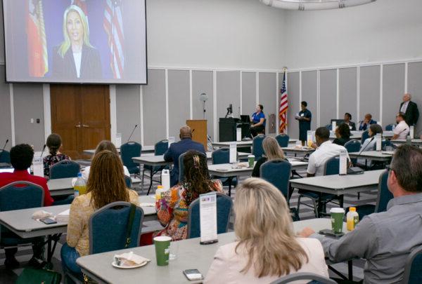 Participants in the task force working on the Creating Safe Spaces and Vision Zero Action Plans listen as Jacksonville Mayor Donna Deegan addresses their meeting.